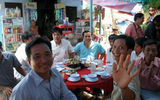 The rickshaw drivers take the group of more than 100 passengers straight through a street-side Vietnamese wedding