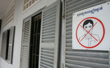 A sign informs visitors to refrain from smiling at S-21