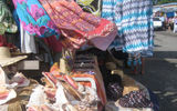 Vendors’ stalls display fabrics, bags, straw baskets and jewelry at the open-air markets on GBI