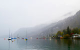 Clouds and rain hang over Wolfgangsee, obstructing views of the mountains that surround the glacial lake