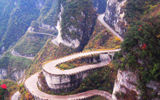 To reach Tianmen Cave, visitors must first travel by bus up a gravel road, climbing more than 3,600 feet in just under 7 miles while negotiating 99 turns. The number 9 has long been linked with good fortune in Chinese culture.