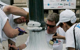 Volunteers paint hallmark New Orleans lampposts. (photo by Judi Bottoni)