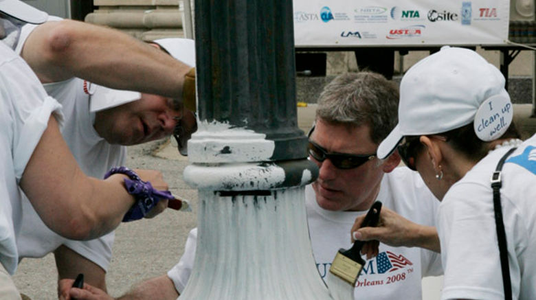 Volunteers paint hallmark New Orleans lampposts. (photo by Judi Bottoni)