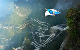 This World Wingsuit League championship competitor chose a quicker way down, foregoing the winding gravel drive beneath him to plunge head first off a 900-foot cliff below Tianmen Cave. Competitors in the race flew under the cableway, hurtling down the course’s 2,600-foot vertical drop before deploying parachutes and landing safely in the valley. Photo courtesy Zhangjiajie Tourism Bureau.