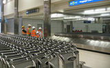 Construction workers view one of the new supersized carousels capable of handling baggage from a fully loaded Airbus A380.