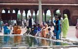 Visitors and worshippers rest at the ablution fountain in the courtyard of the Jama Masjid, India's largest mosque, in the heart of Old Delhi.