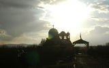 An Orthodox church, backlit by the sun breaking through clouds at the site of Bethany Beyond the Jordan. (photo by Arnie Weissmann)