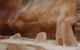 The eroded remains of a bas-relief sculpture of a man leading a camel is carved into the walls of the canyon leading to the Treasury in Petra. (photo by Arnie Weissmann)
