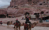 The Urn Tomb rises above simpler cave tombs in Petra. (photo by Arnie Weissmann)