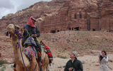 Why walk when you can ride? A camel driver tries to persuade a tourist to hop aboard. The Royal Tombs are in the background. (photo by Arnie Weissmann)