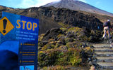 Hikers pass a warning sign aimed at deterring the unprepared at the base of the Tongariro Alpine Crossing's first real climb. Travelers interested in tackling the trail with an expert guide can book a day with Adrift Outdoor Guided Adventures, a company that provides everything from warm clothing, waterproof gear, hiking boots and a picnic lunch along with all sorts of geologic, cultural, botanical and birding insight.