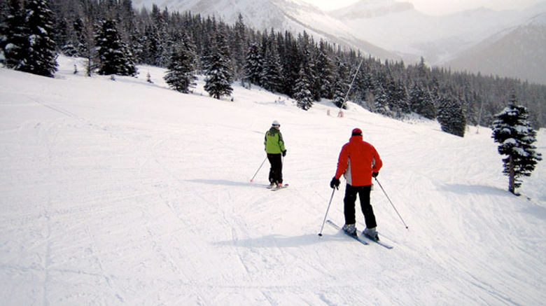 Skiers at the top of a slope at Lake Louise ski resort.