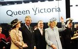 Camilla, Duchess of Cornwall, names the Queen Victoria in Southampton on Dec. 10, 2007, sharing the stage with her husband, Prince Charles, and (far left) Cunard president Carol Marlow.