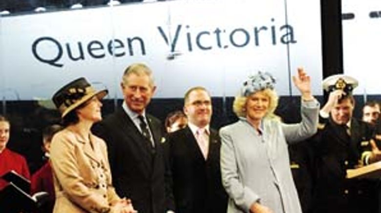 Camilla, Duchess of Cornwall, names the Queen Victoria in Southampton on Dec. 10, 2007, sharing the stage with her husband, Prince Charles, and (far left) Cunard president Carol Marlow.