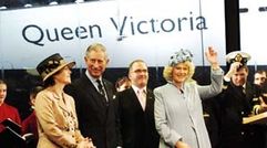 Camilla, Duchess of Cornwall, names the Queen Victoria in Southampton on Dec. 10, 2007, sharing the stage with her husband, Prince Charles, and (far left) Cunard president Carol Marlow.