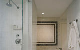 A shot of part of the guest bathrooms at the London West Hollywood, which have mosaic-tiled floors and walls, two showers and a separate bathtub.