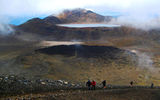 Clouds part over Blue Lake, a freshwater basin filling a volcanic lava vent on Mount Tongariro. The lake reaches up to 50 feet in depth and is acidic with a PH level of approximately 5.
