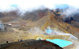 Hikers photograph Tongariro's Emerald Lakes, which are also acidic with a PH level of around 3.5 and owe their bright color to minerals like sulfur that leach into the fresh water from nearby geothermal vents.