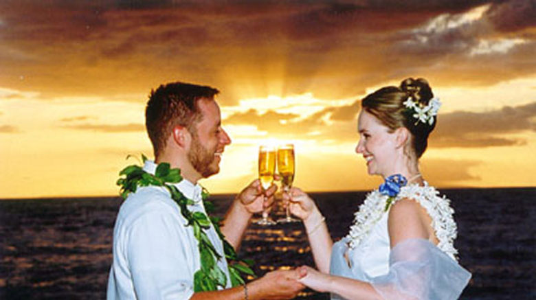 Ronnie and Angela Points toast their nuptials at Maluaka Beach. (photo courtesy of Hawaiian Island Weddings)
