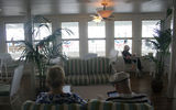 Passengers read their tablet devices in the Front Porch of America lounge.