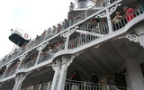 Passengers look on as Great American Steamboat Company President Christopher Kyte gives a speech at the christening ceremony.