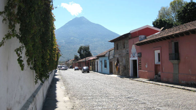 Long dormant and one of four volcanoes in the area, Volcan de Agua looms over the Antigua streetscape.