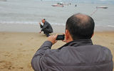 A man poses for a photo, displaying the Asian gesture meaning, "I'm having my photo taken."