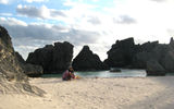 A family plays in a sheltered cove at Horseshoe Bay beach on Bermuda, renowned for its pink-tinged sands.