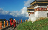 Two monks circumnavigate the 100 chortens atop 9,900-foot Dochula Pass.