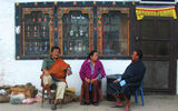 Three residents of Paro. The man on the right is wearing a gho, the national dress of Bhutan.