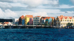 The buildings have their bright colors because a prior ruler suffered migraines and the bright colors lessened the effects.