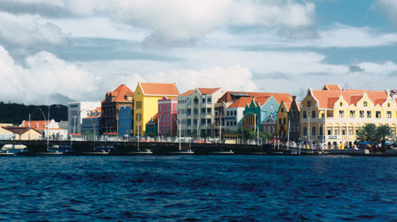 The buildings have their bright colors because a prior ruler suffered migraines and the bright colors lessened the effects.