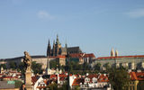 Prague's Castle Hill seen from the Charles Bridge. One of the bridge's famous statues is visible in the foreground.