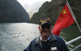 Dick Carpentier, senior cruise director on the VIctoria Jenna, sails through one of the Three Little Gorges on CHina's Danang River, now accessible thanks to flooding.