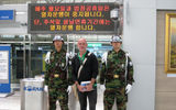 Posing with South Korean military police at Korail's ultramodern but unused Dorasan DMZ train station.
