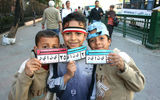 Egyptian kids outside the Egyptian Museum in Cairo show off their "January 25" bumper stickers and an Egyptian flag headband.
