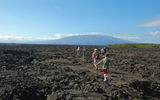 Guests on the yacht La Pinta traverse the rugged landscape of Isabella Island, the largest of the Galapagos. Five of its six volcanoes are active.
