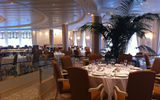 The Riviera's Grand Dining Room features golden hues, original artwork and live plants.