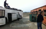 The large, flat area that was swept clean by the tsunami has become a staging area for damaged vehicles and other items awaiting dismantlement or removal. A train car (right) and tour bus are examined by CBS Travel Editor Peter Greenberg and cameraman Mark Wexler (on the bus), Taj Hotels and Resorts CEO Raymond Bickson (leaning against the bus) and Travel Corp CEO Bret Tollman. Photo by Arnie Weissmann