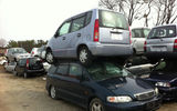 Cars damaged by the water are stacked up, awaiting their turn to be salvaged for parts. Photo by Arnie Weissmann