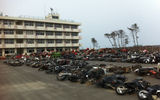 Tsunami-damaged motorcycles sit in the yard of an abandoned school, one of the few structures to survive the full impact of the tsunami. Two hundred children waited for days on its roof to be rescued. The only student who died was one whose mother had heard about the earthquake and picked up the child before the tsunami hit. Photo by Arnie Weissmann