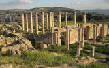 An ancient temple complex at Jerash frames a view of the modern Jordanian town.