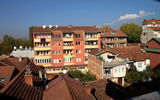 A brightly painted apartment house is the centerpiece of this city view in Pristina.