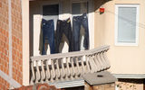 Laundry dries in the bright sun on an apartment balcony in the Kosovo capital, Pristina.