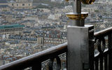The steel and brass of an Eiffel Tower telescope find an echo in the stone and gold of the distant Sorbonne.