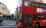 One of London's iconic double-decker buses traverses Piccadilly Circus.