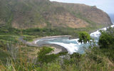 A sandy beach fronts the bay at the eastern edge of Molokai's Halawa Valley.