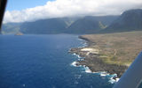 This image, taken shortly after take off, features the jagged, lava rock shoreline of the peninsula's eastern coast and Molokai's sea cliffs in the distance.