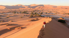 The land of sand and big game has drawn kudos and controversy with its pursuit of an independent approach to wildlife management that challenges both travelers and the industry to reassess what it means to be a responsible tourist. Shown here, Heidi Huettmann of Stutgart, Germany, and her husband Helmut, climb the Big Mama sand dune in the Sossusvlei section of Namib-Naukluft National Park. Photos by Arnie Weissmann