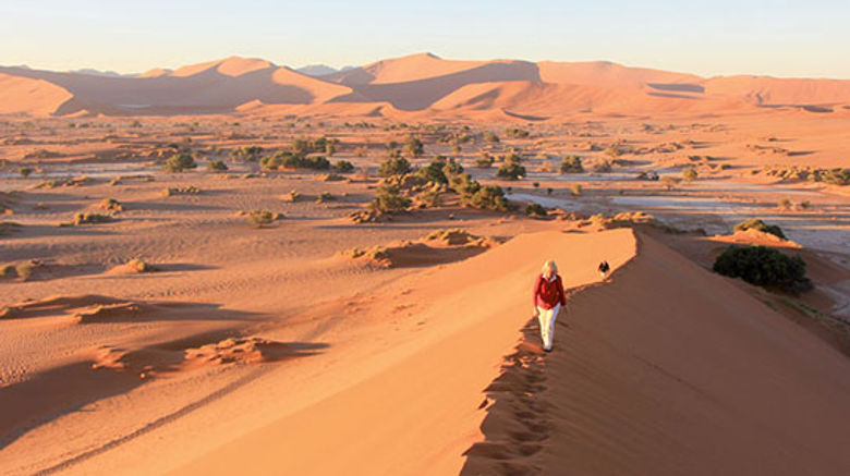The land of sand and big game has drawn kudos and controversy with its pursuit of an independent approach to wildlife management that challenges both travelers and the industry to reassess what it means to be a responsible tourist. Shown here, Heidi Huettmann of Stutgart, Germany, and her husband Helmut, climb the Big Mama sand dune in the Sossusvlei section of Namib-Naukluft National Park. Photos by Arnie Weissmann
